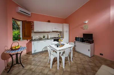 a kitchen with a table and chairs in a kitchen at Villa Oasi del Relax Flavianna in Castellammare del Golfo