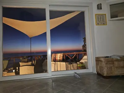 a sliding glass door with a view of the ocean at Mare e cielo in Porticello