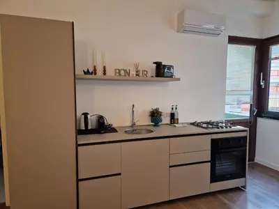 a kitchen with a sink and a stove top oven at SPRING APARTMENTS in Palermo