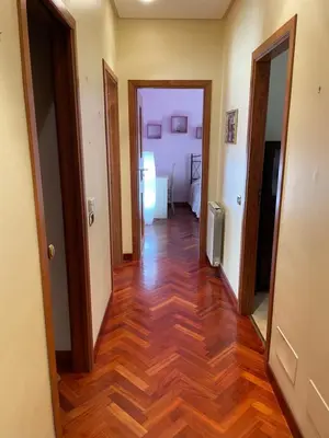 a hallway with two doors and a hard wood floor at Casa Michela in Palermo