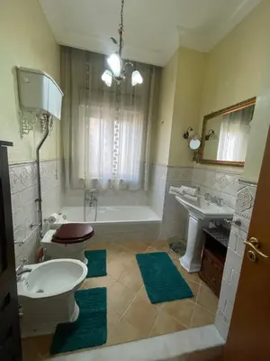 a bathroom with a tub and a toilet and a sink at Casa Michela in Palermo