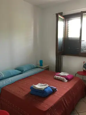 a bedroom with a bed with two towels on it at Casa al mare a Campofelice di Roccella - Cefalù in Lascari