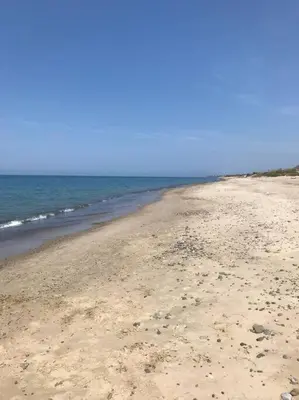 a sandy beach with the ocean in the background at Casa al mare a Campofelice di Roccella - Cefalù in Lascari
