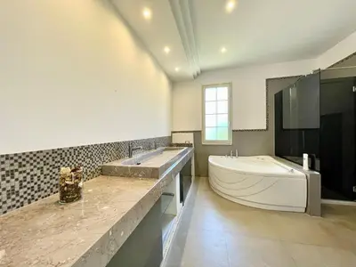 a bathroom with a large tub and a sink and a tub at Villa Rachele con piscina in Balestrate