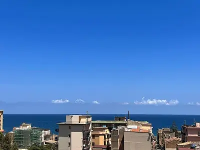 a view of a city with the ocean in the background at harriets house in Palermo
