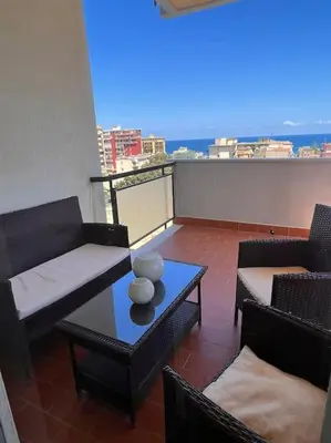 a balcony with chairs and a table with a view at harriets house in Palermo