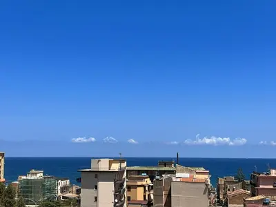a view of a city with the ocean in the background at harriets house in Palermo