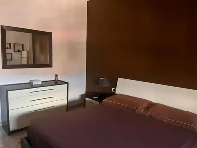 a bedroom with a bed and a dresser and a mirror at harriets house in Palermo
