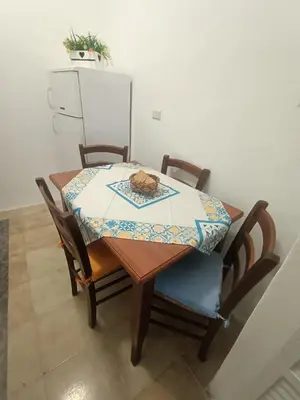 a table and chairs with a table cloth on it at La casetta di Toto' in Isola delle Femmine
