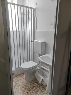 a bathroom with a toilet and a sink at La casetta di Toto' in Isola delle Femmine
