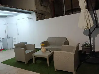 a living room with two chairs and a table at La casetta di Toto' in Isola delle Femmine