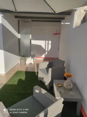 a living room with a couch and a table at La casetta di Toto' in Isola delle Femmine