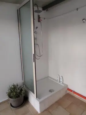 a shower stall in a bathroom with a plant at La casetta di Toto' in Isola delle Femmine