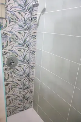 a bathroom with a shower with a tile wall at Pilly House Rinascente in Palermo