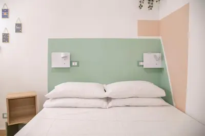 a bedroom with a bed with white pillows at Pilly House Rinascente in Palermo