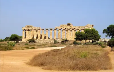 an ancient building in the middle of a field at Casa San Giovanni in Giuliana