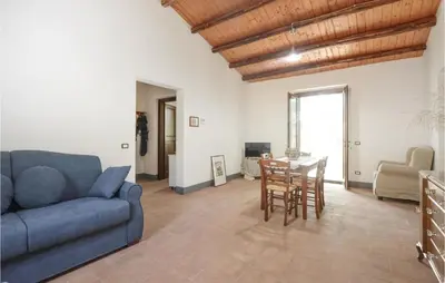 a living room with a blue couch and a table at Casa San Giovanni in Giuliana