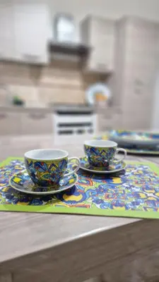 two cups and saucers on a mat on a table at CasaVe in Palermo