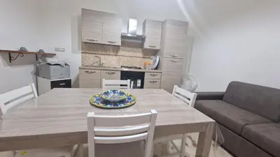 a kitchen and dining room with a table and a couch at CasaVe in Palermo