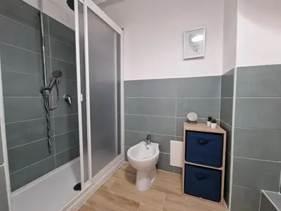 a bathroom with a toilet and a shower at Casa di Leda 2 in Santa Flavia