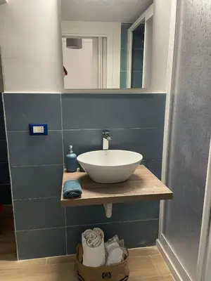 a bathroom with a sink and a mirror at Casa di Leda in Santa Flavia