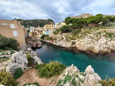 a view of a river in a town with buildings at Casa di Leda in Santa Flavia
