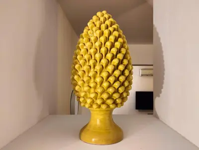 a yellow vase with a pineapple on top of it at Alvarado - Your Home in Sicily in Carini