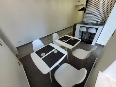 an overhead view of a dining room with white chairs and a table at SP Rooms in Isola delle Femmine