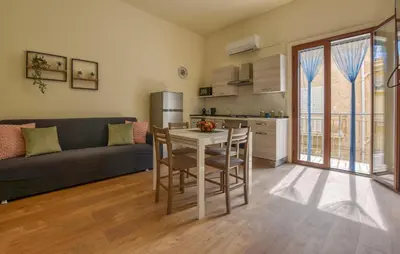 a living room with a couch and a table with chairs at Beautiful Apartment In Trappeto in Trappeto