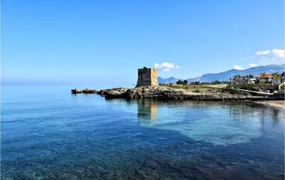 an island with a castle in the middle of the water at Beautiful Apartment In Trappeto in Trappeto