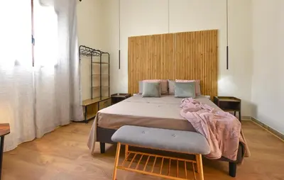 a bedroom with a large bed with a wooden headboard at Beautiful Apartment In Trappeto in Trappeto
