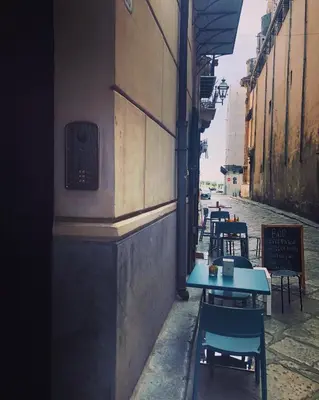 a row of tables and chairs on a street at Casa degli Allori in Palermo