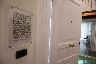 a white door with a picture on the wall at Casa degli Allori in Palermo
