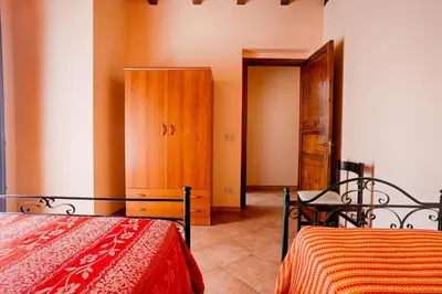 a bedroom with a bed and a wooden cabinet at GuestHost - Corso Garibaldi - Castellammare Central Flats in Castellammare del Golfo