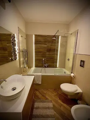 a bathroom with a tub and a toilet and a sink at Casa Batù alle porte del Capo in Palermo