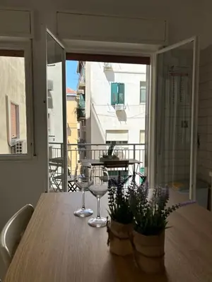 a table with two wine glasses on a balcony at 4 Country Side - City Center in Palermo