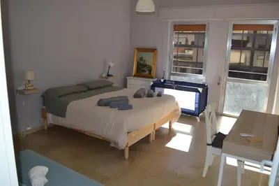 a bedroom with a bed and a table and a piano at 4 Country Side - City Center in Palermo