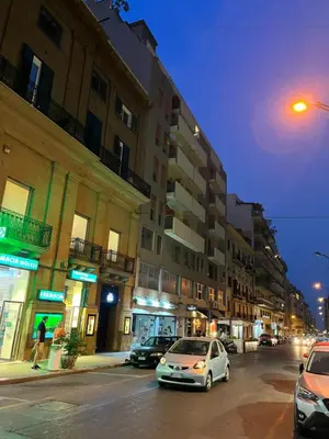 a city street with cars parked in front of buildings at 4 Country Side - City Center in Palermo