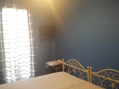 a bedroom with a bed and a window at Bed And Breakfast Marina d'Aspra in Bagheria