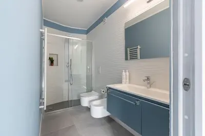 a blue bedroom with a bed and a blue wall at Casa Azul alla Cala by Wonderful Italy in Palermo