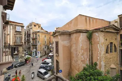 a city street with parked cars and buildings at iFlat Casa Ponticello Kemonia in Palermo