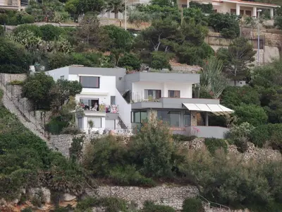 a white house on a hill with trees at Vero Sicily - Villa Acqua Chiara in Bagheria