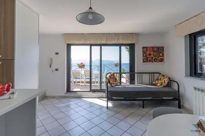 a living room with a couch and a balcony at Vero Sicily - Villa Acqua Chiara in Bagheria