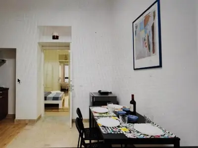 a dining room with a table with plates on it at Star Politeama apartment, in centro città. in Palermo
