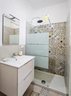 a white bathroom with a sink and a shower at Star Politeama apartment, in centro città. in Palermo