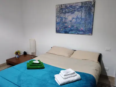 a bedroom with a bed with towels on it at Star Politeama apartment, in centro città. in Palermo