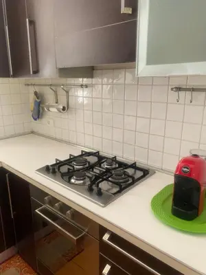 a kitchen with a stove with a toaster on a counter at MONTE PELLEGRINO HOUSE AND TERRACE in Palermo