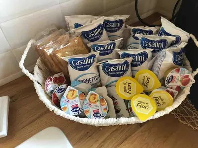 a basket filled with different types of chips and bread at Appartamento NA ME CASA in Palermo