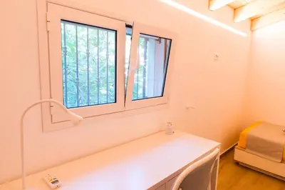 a room with a window and a white table at White Home in Castellammare del Golfo