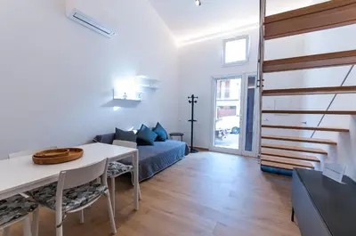 a living room with a couch and a table at White Home in Castellammare del Golfo